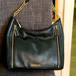 Slightly used Michael Kors handbag black and gold